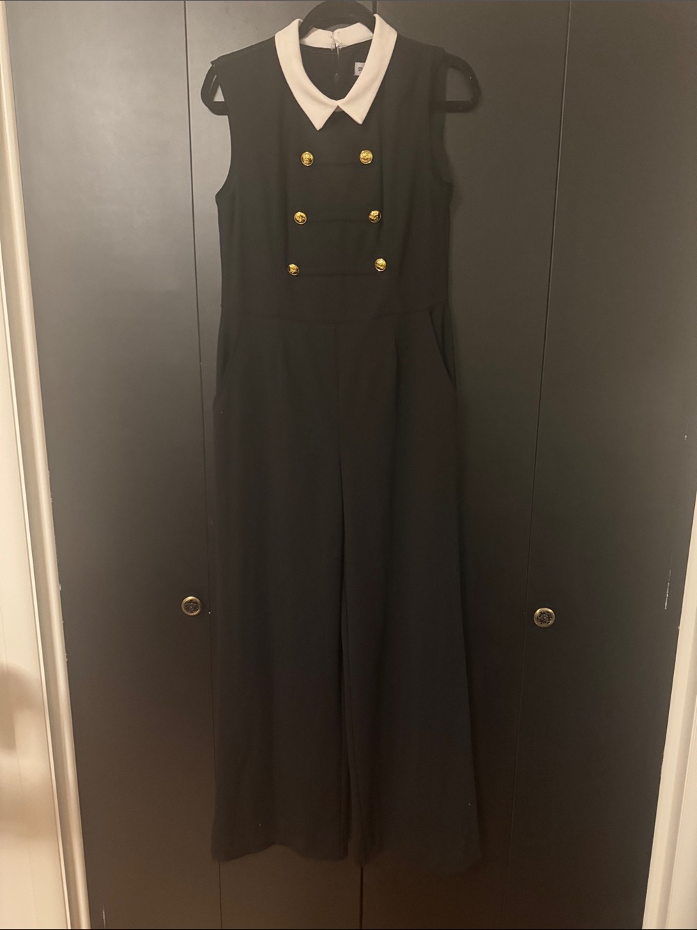 Sleeveless Black Jumpsuit with White Collar and Gold Buttons